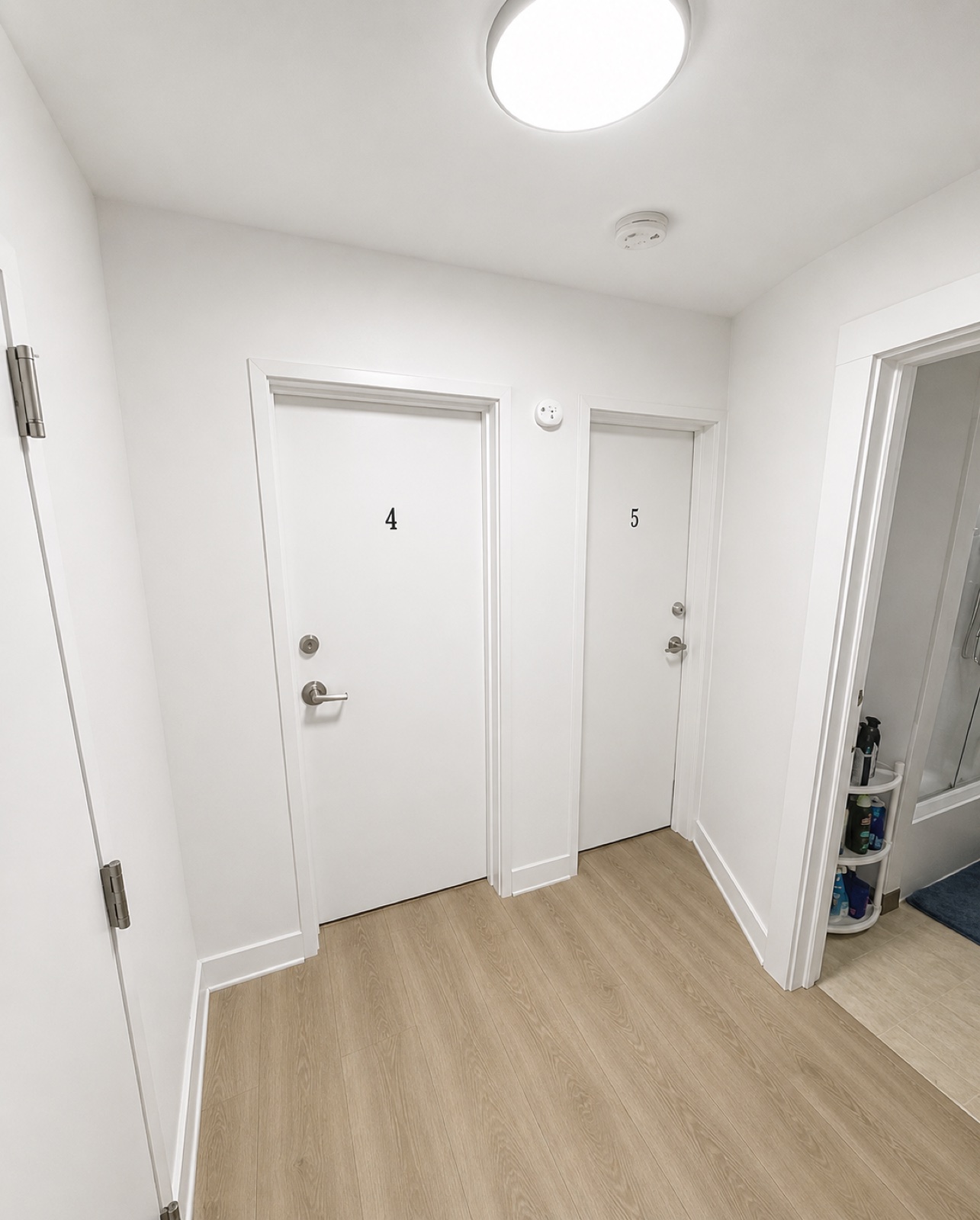 Interior hallway showing numbered doors to private boarding rooms