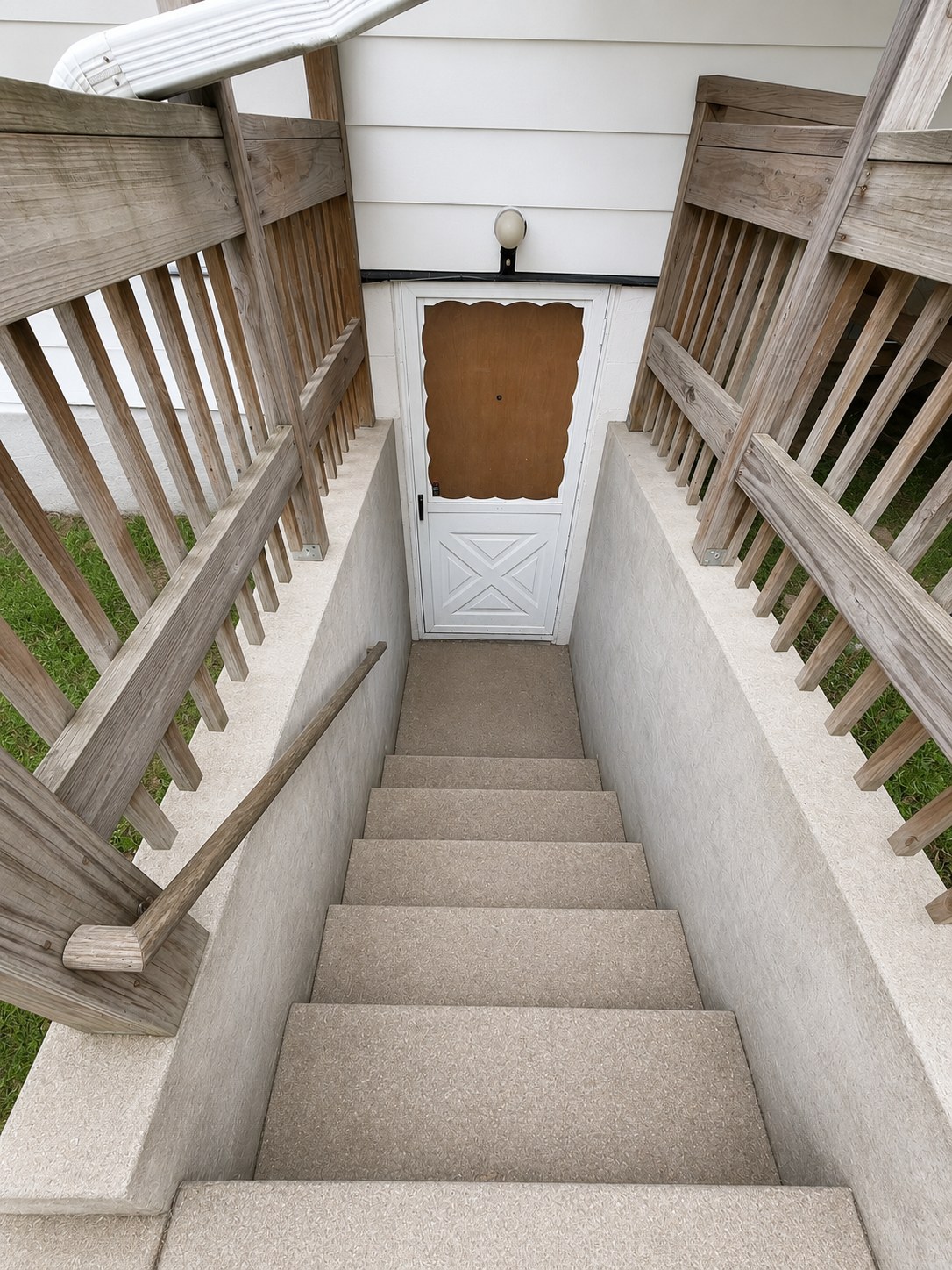 Private rear entrance to the one-bedroom apartment via covered stairwell
